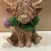 Highland Cow Holding A Thistle Ornament
