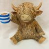 Highland Cow Holding A Cuppa