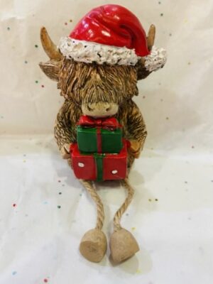 Dangly Leg Highland Cow Holding Gifts